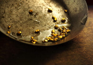 Nuggets of gold in a pan symbolising extraction of process mining value